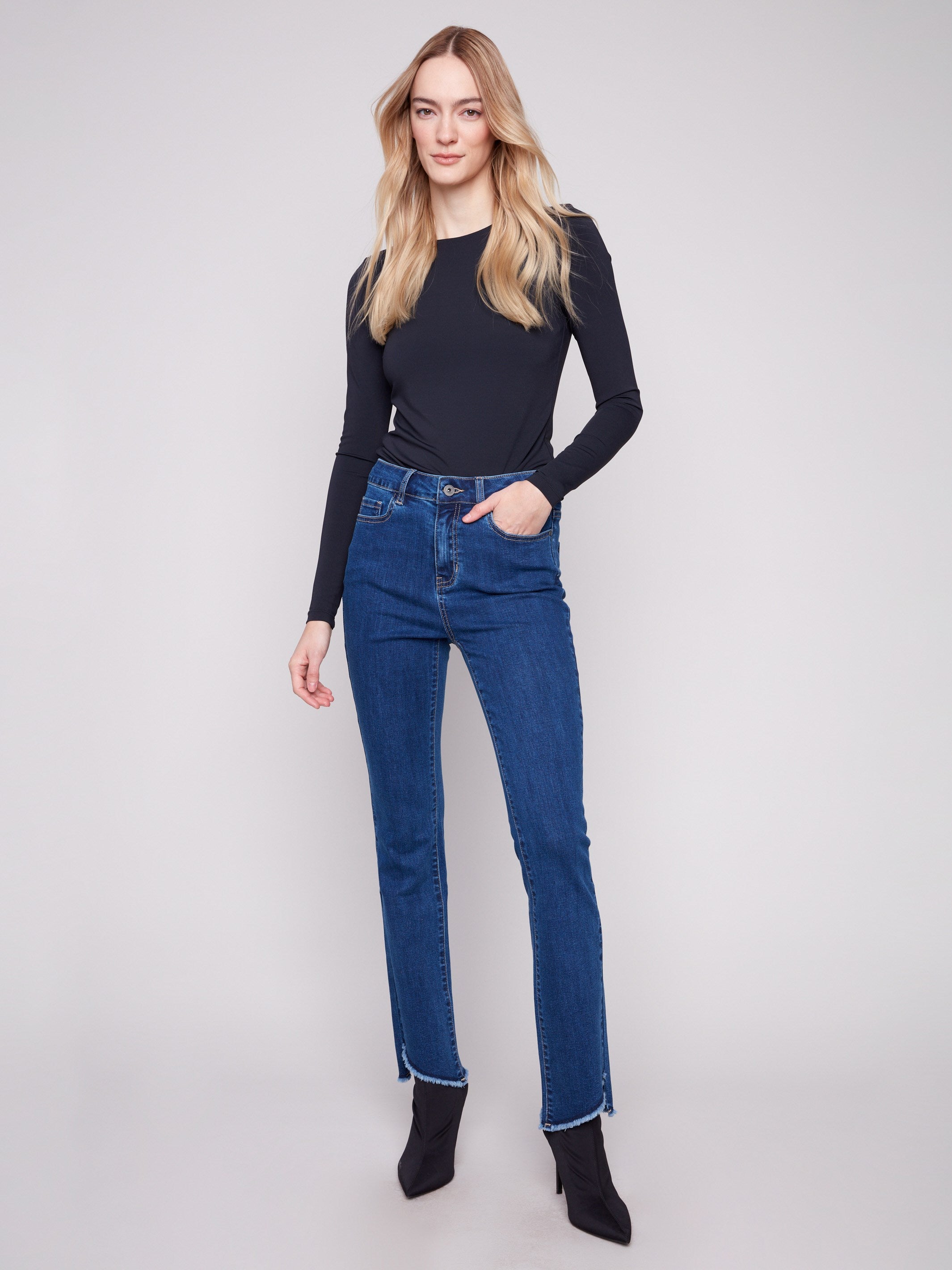 Experience the flattering long length of these indigo bootcut jeans with stretch fabric by Charlie B.