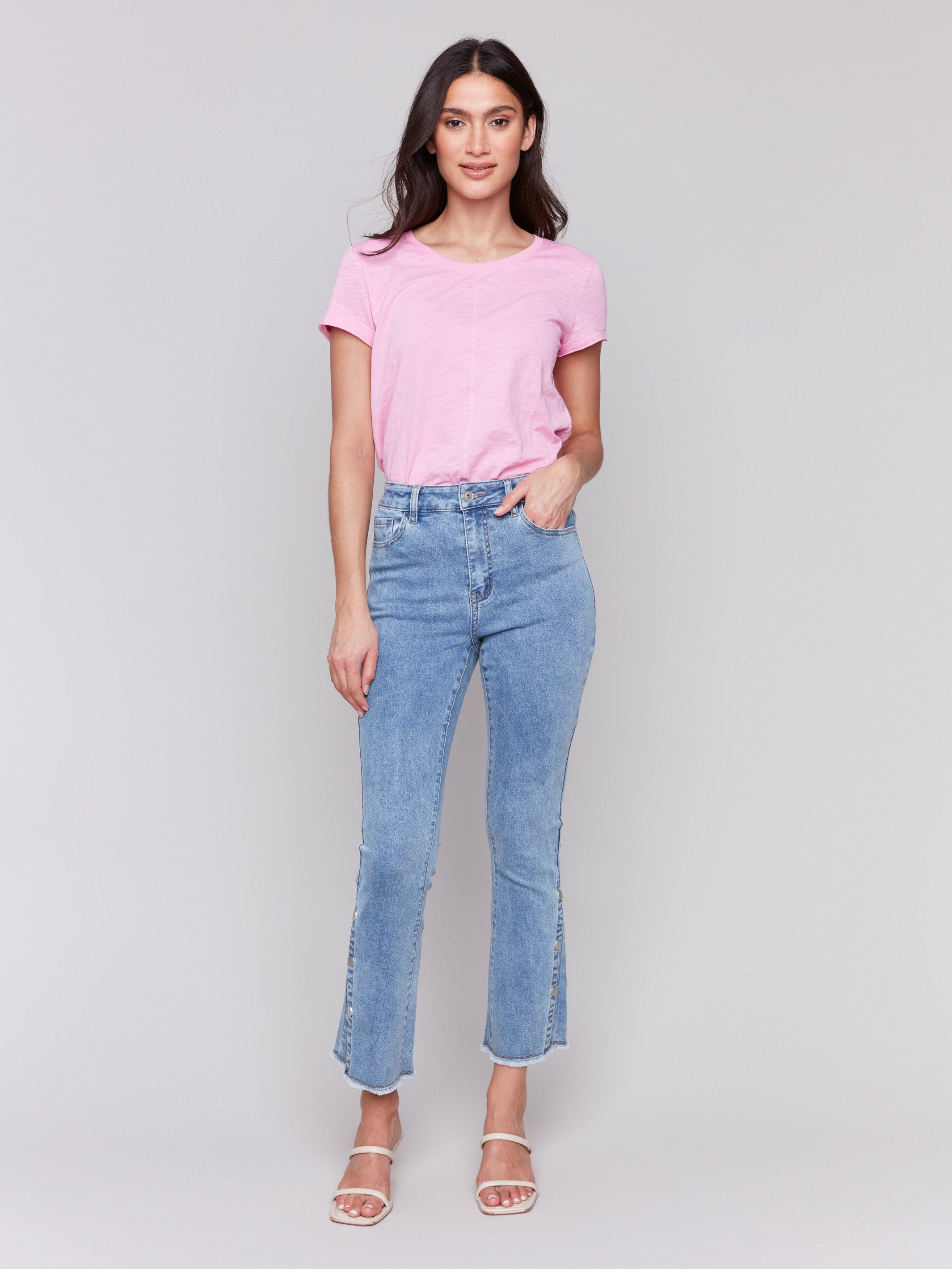 Light blue jeans with a bootcut fit, showcasing cropped length by Charlie B.
