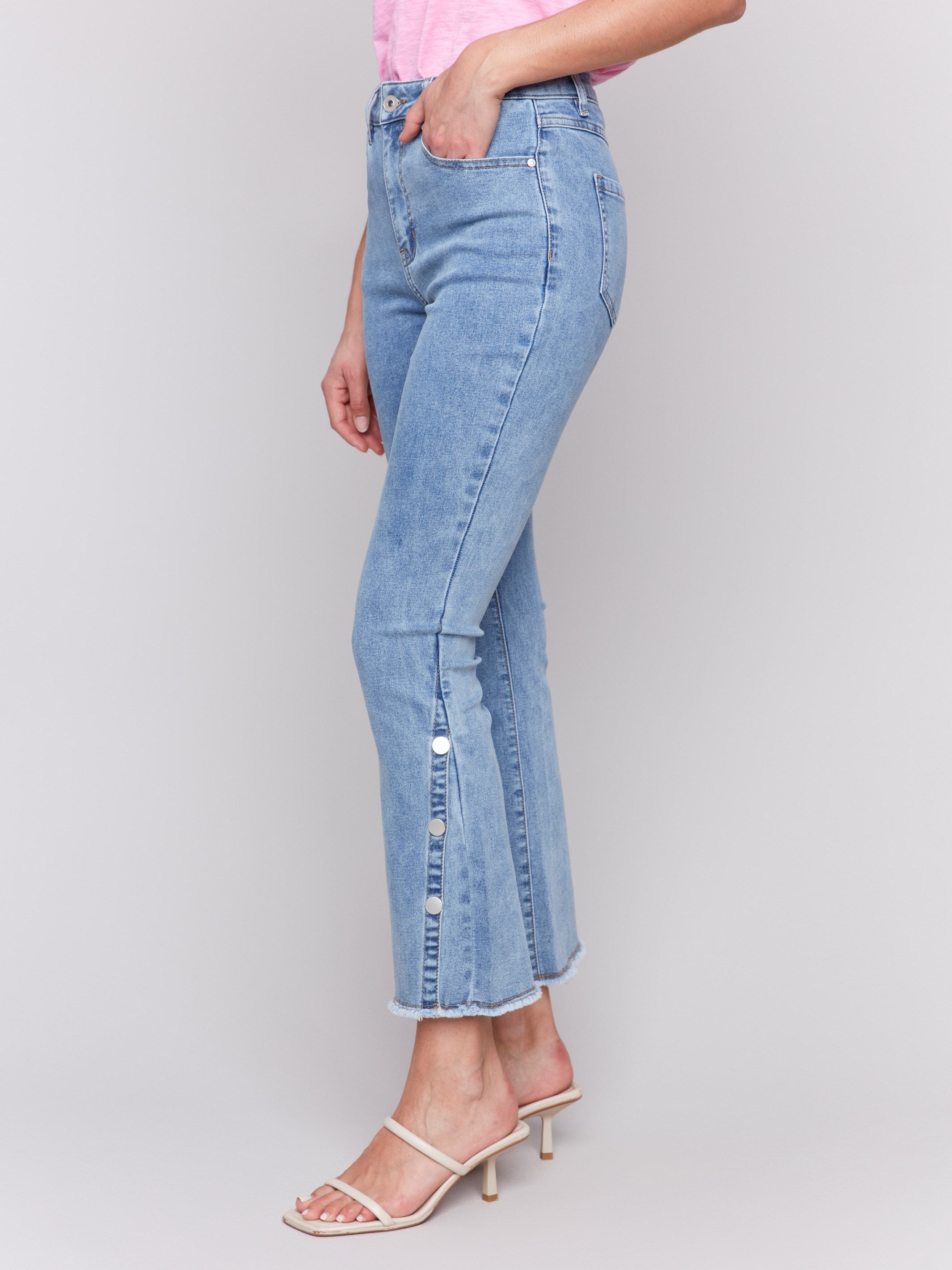 Stylish light blue jeans featuring side snap detail and stretch denim by Charlie B.
