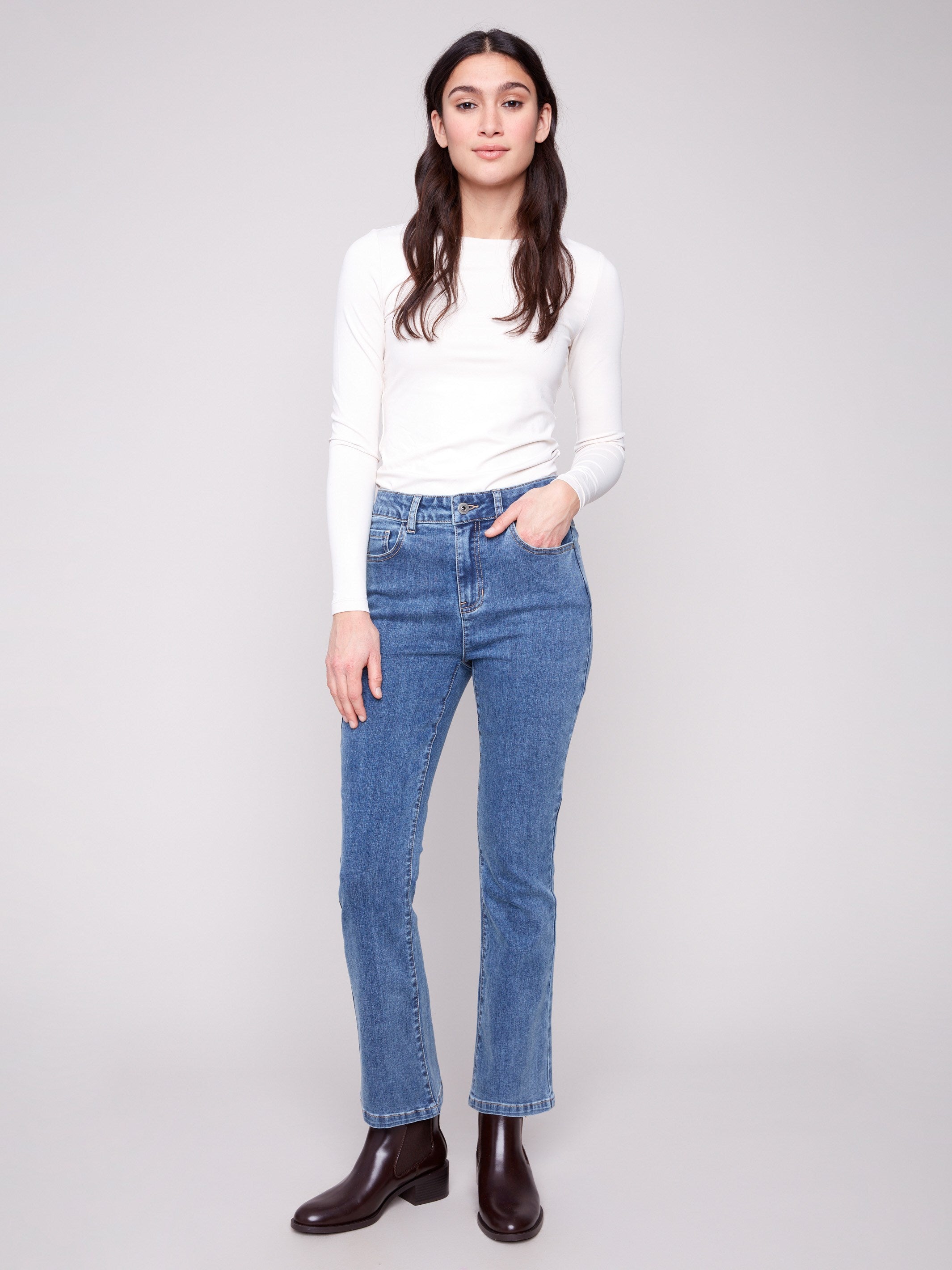 Medium blue denim pants featuring a bootcut fit and stretch fabric, offering comfort and style by Charlie B.