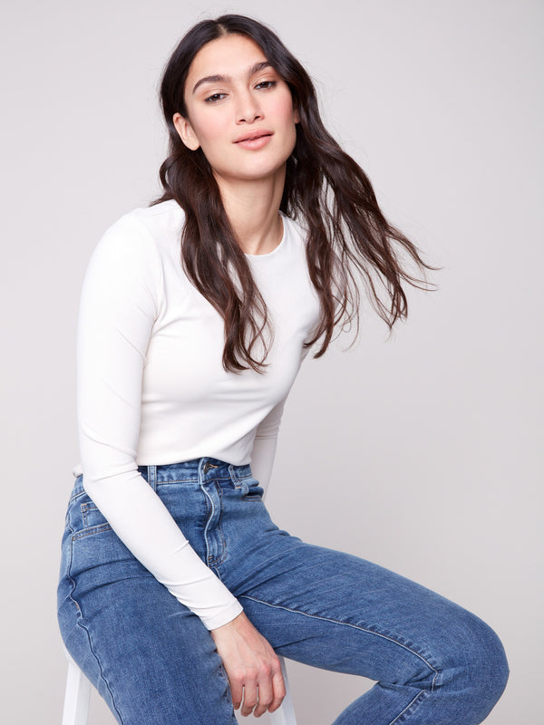 Medium blue bootcut denim pants by Charlie B with a classic five-pocket design and regular rise.