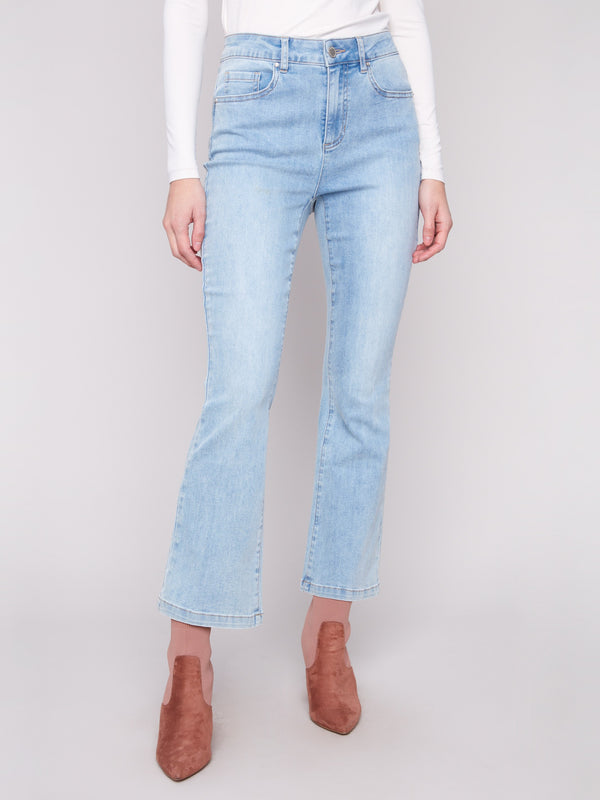 Mid-rise light blue jeans by Charlie B with five practical pockets, perfect for everyday wear and style.