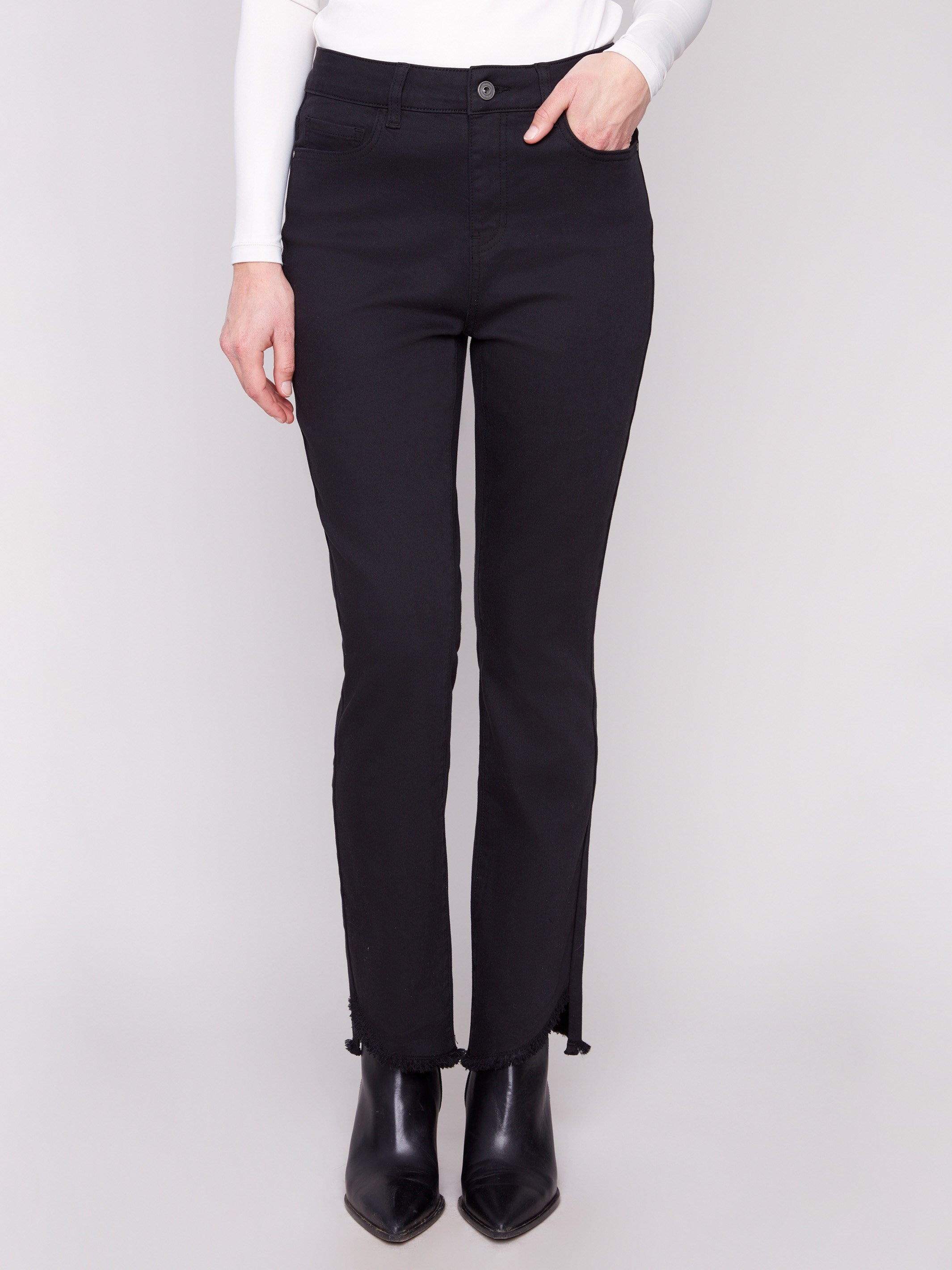 Stylish black pants with asymmetrical fringed hem, offering a chic look in stretch twill by Charlie B.