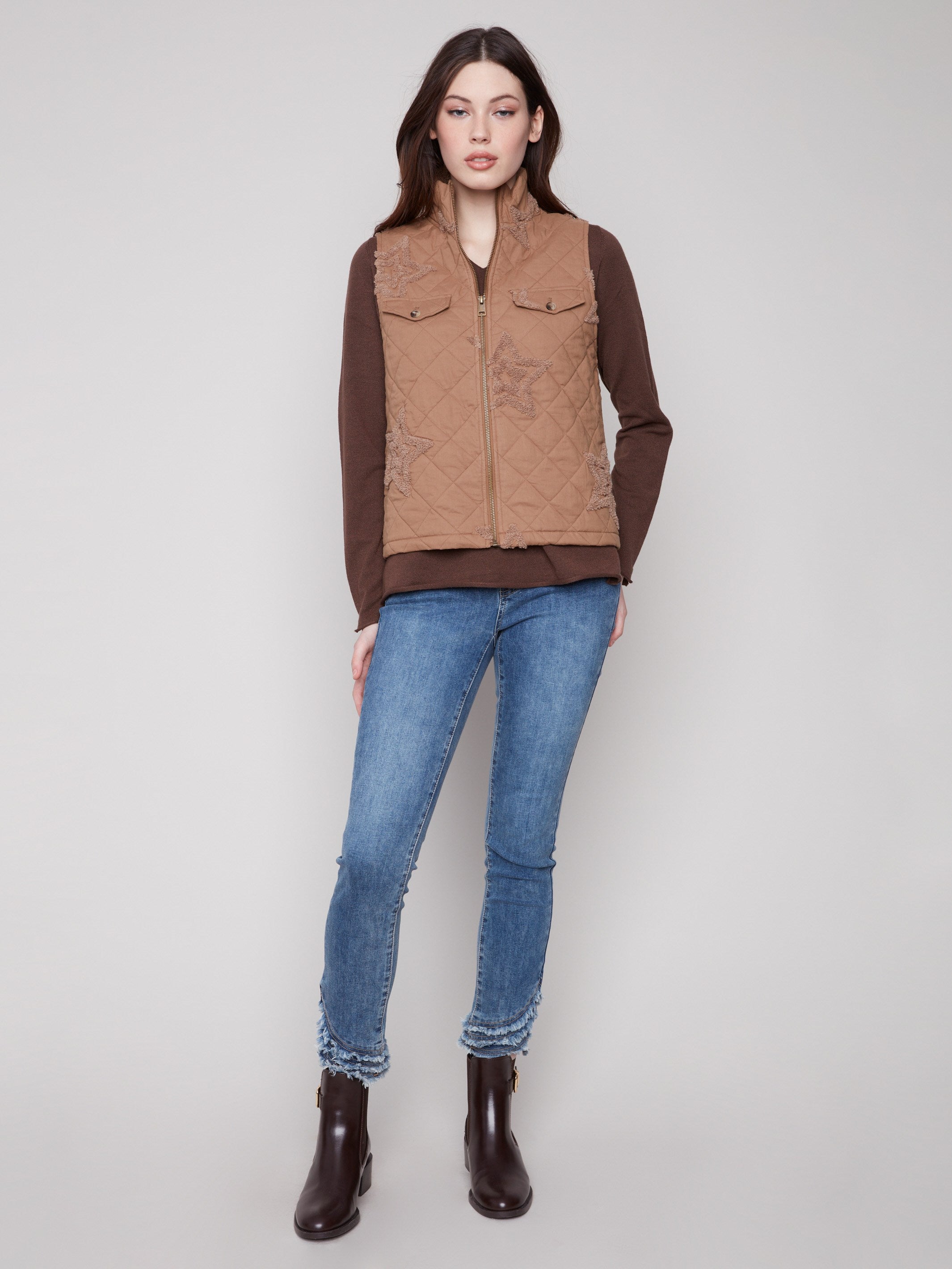 This khaki vest showcases intricate bouclé star details, adding a unique touch to your ensemble by Charlie B.
