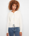 Ecru cardigan featuring a crew neckline and soft jacquard knit texture, accented with tie-front bows by Charlie B.