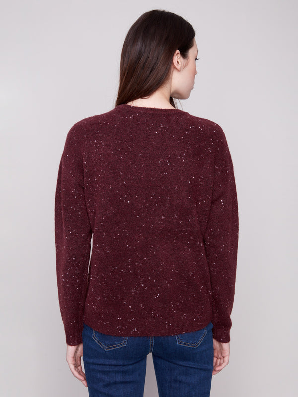 Elegant cabernet sweater featuring long sleeves and a charming braided 'Love' detail, ideal for cooler days by Charlie B.