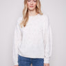 Ecru sweater with a crew neck, showcasing a charming braided 'Love' detail and colorful speckled pattern by Charlie B.