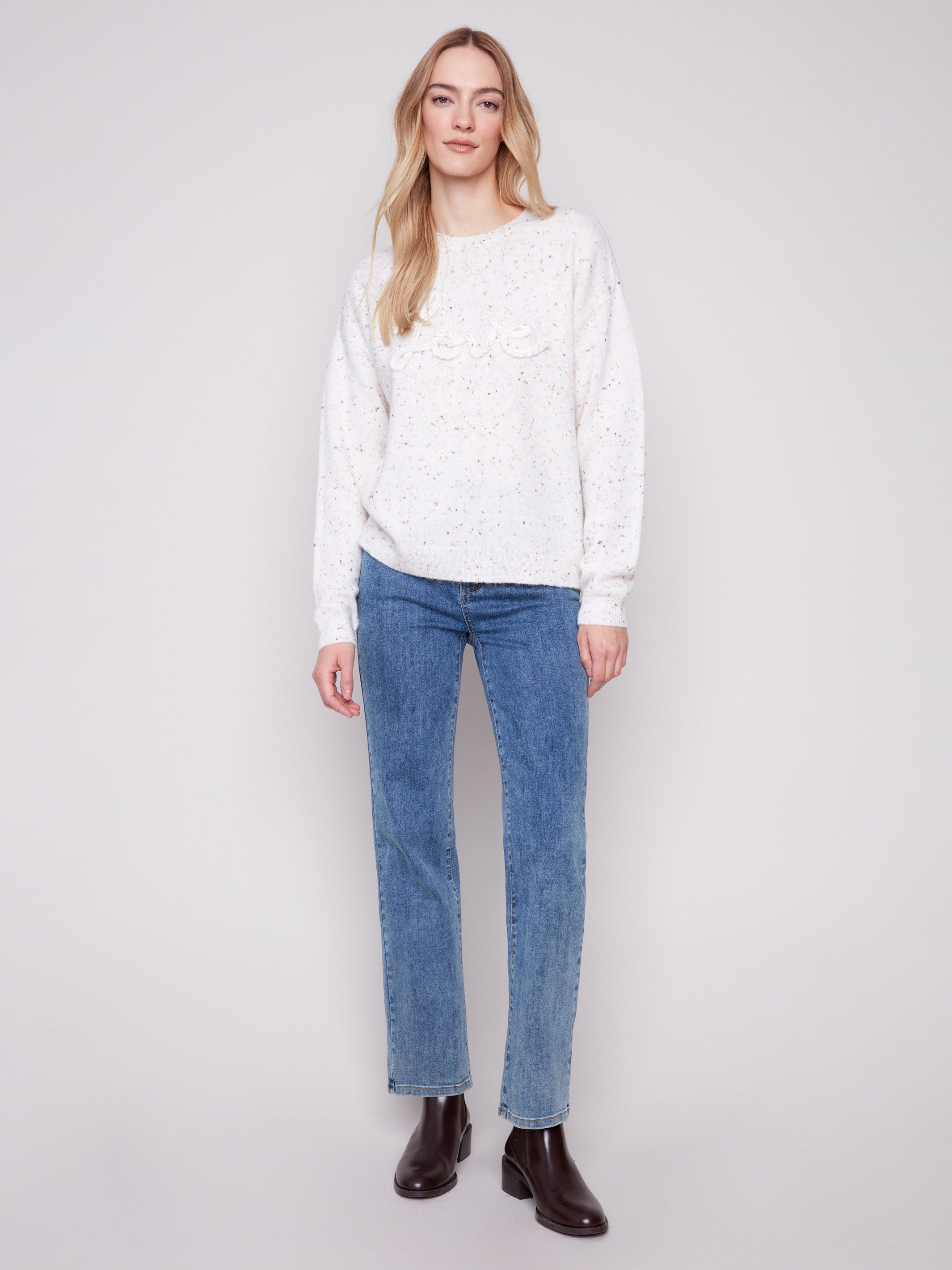 Elegant drop shoulder design on this ecru sweater with intricate braided 'Love' detail by Charlie B.