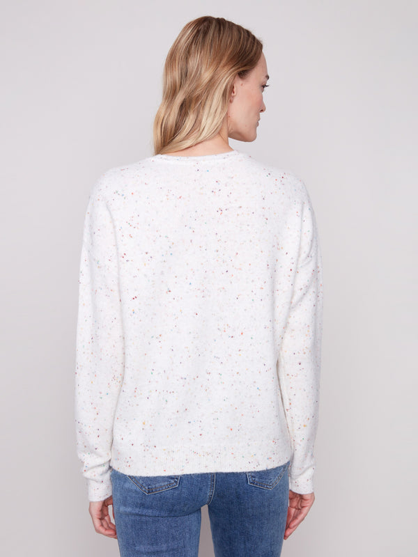 Chic ecru sweater showcasing the braided 'Love' design, enhanced with a crew neck style by Charlie B.