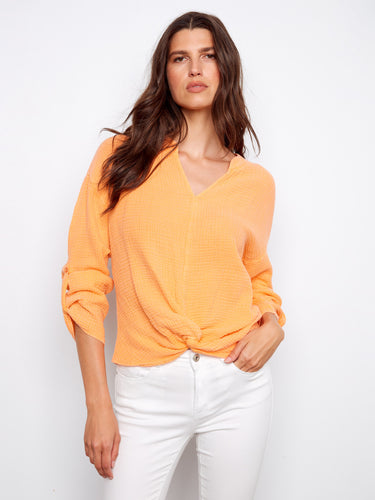 Fashion-forward top in bright orange, showcasing a fashionable notch neckline and knot detail. Crafted in pure cotton by Charlie B.