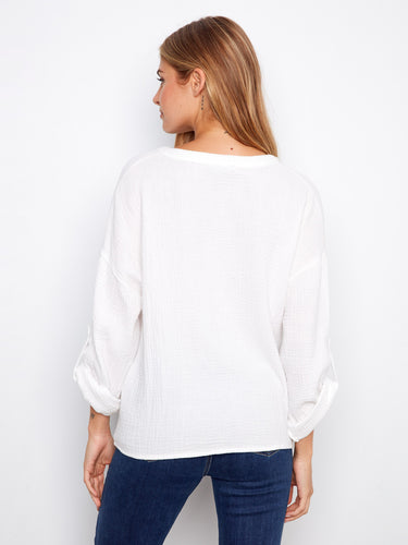 White blouse made from 100% cotton, showcasing a trendy notch neckline and elegant design by Charlie B.