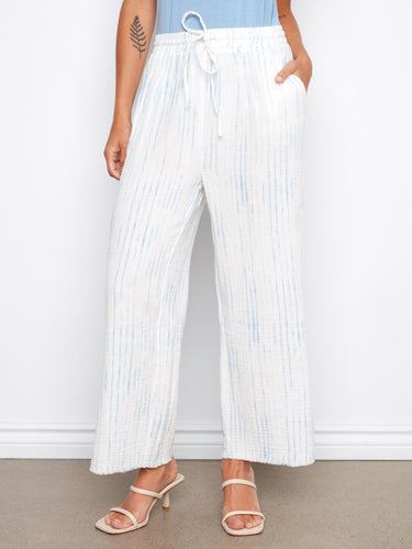 Stylish white and blue striped pants with side slits, enhancing breathability and movement by Charlie B.