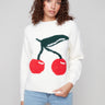 White sweater with cherry design featuring a classic crew neck, adding a playful touch to any outfit by Charlie B.