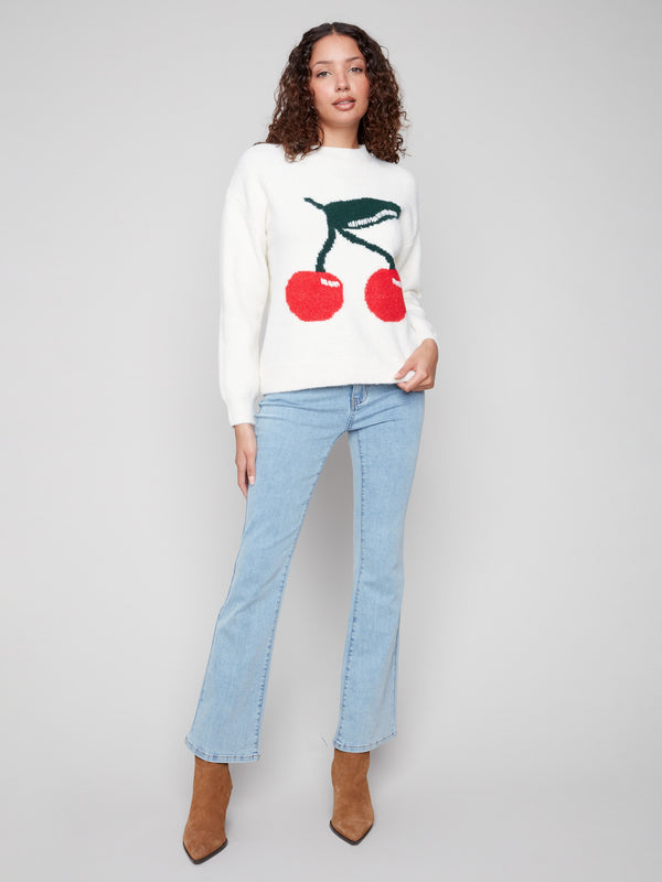 Charming white sweater with bold cherry pattern and drop shoulders for a relaxed fit by Charlie B.