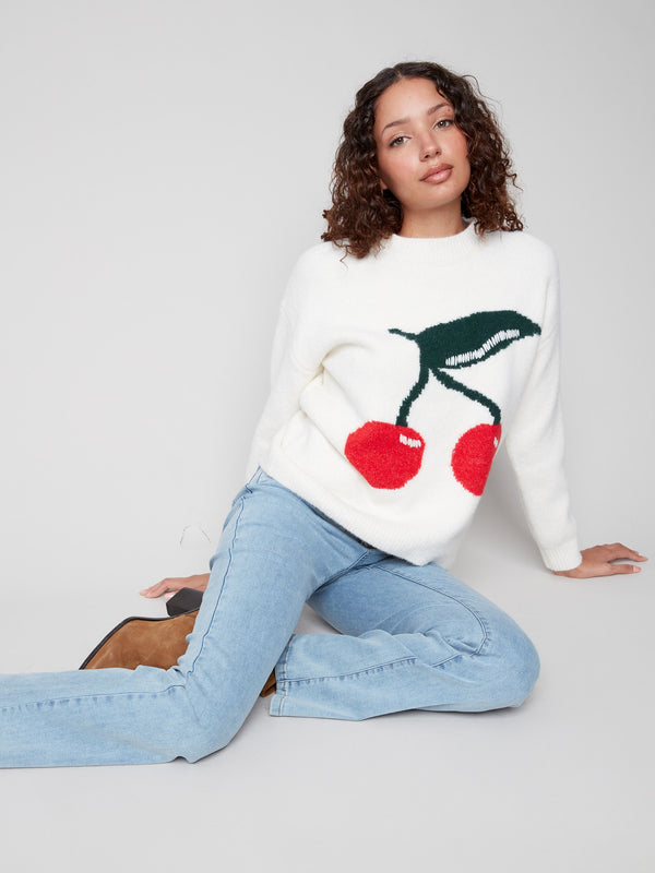 Vibrant cherry design on a cozy white intarsia sweater, crafted with attention to detail by Charlie B.
