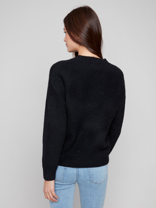 Elegant black sweater with drop shoulders, offering comfort and modern style by Charlie B.