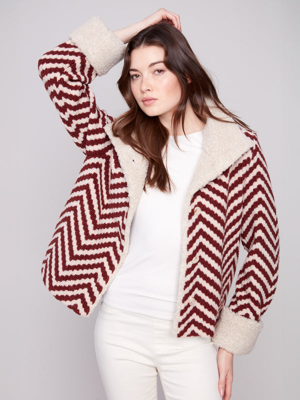Chevron Boucle Jacket with button closure, adding a stylish touch to any outfit. Features faux sherpa details for warmth by Charlie B.