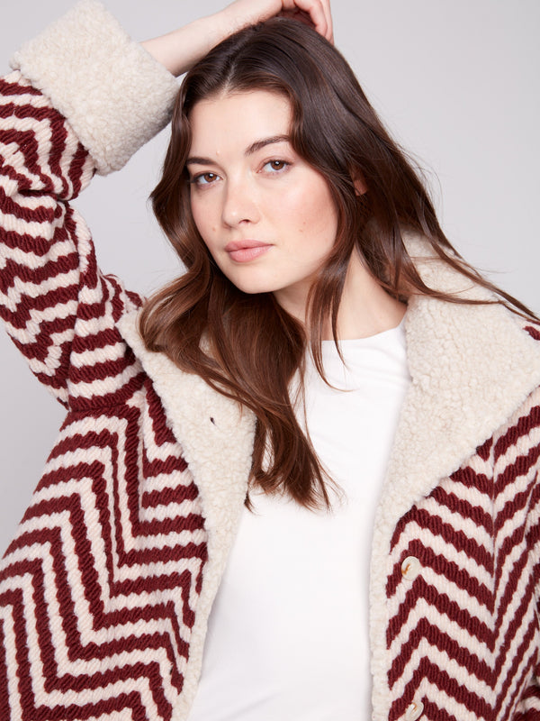 Boucle Chevron Jacket showcasing faux sherpa trim on cuffs, offering a cozy yet fashionable look for cooler days by Charlie B.