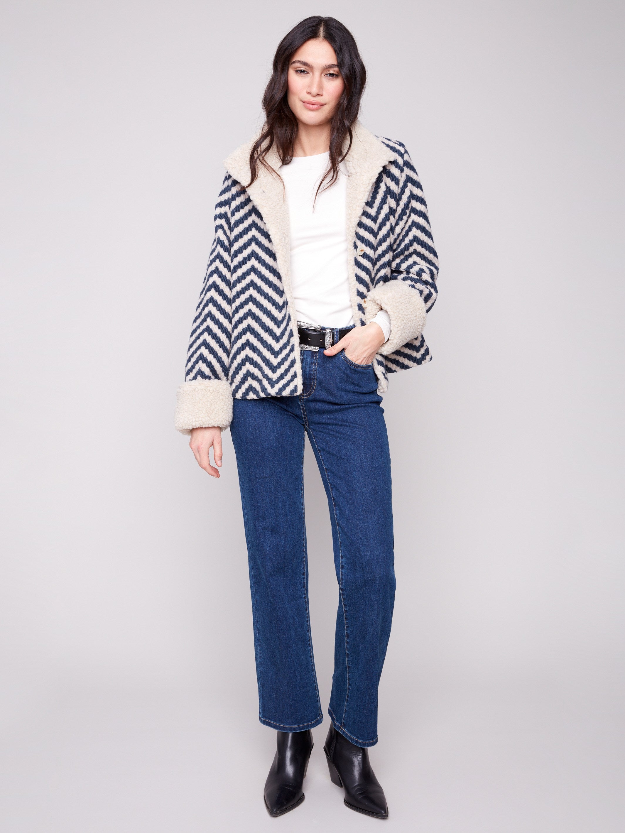 Navy Chevron Boucle Jacket showcasing a distinctive button closure, paired with a stylish design and cozy sherpa details by Charlie B.