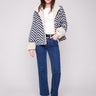 Navy Chevron Boucle Jacket showcasing a distinctive button closure, paired with a stylish design and cozy sherpa details by Charlie B.