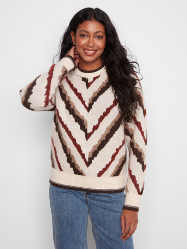 Sweater with a classic crew neck design, featuring bold chevron patterns in earthy tones. Perfect for casual outings. By Charlie B.