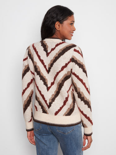 The sweater's intricate design showcases rich colors and textures, making it a standout piece for any wardrobe. By Charlie B.