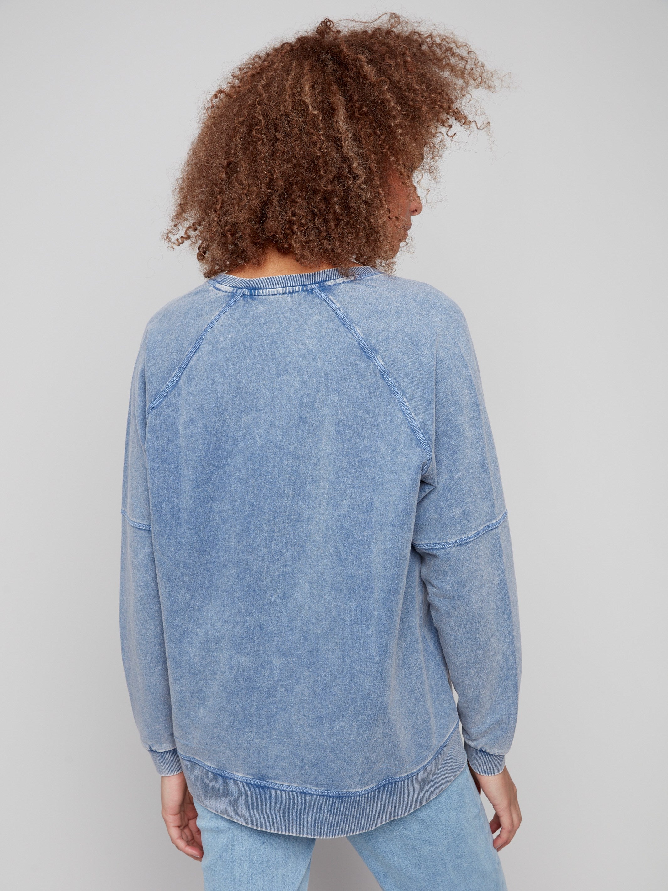 Versatile V-neck denim top designed with raglan sleeves for added comfort by Charlie B.