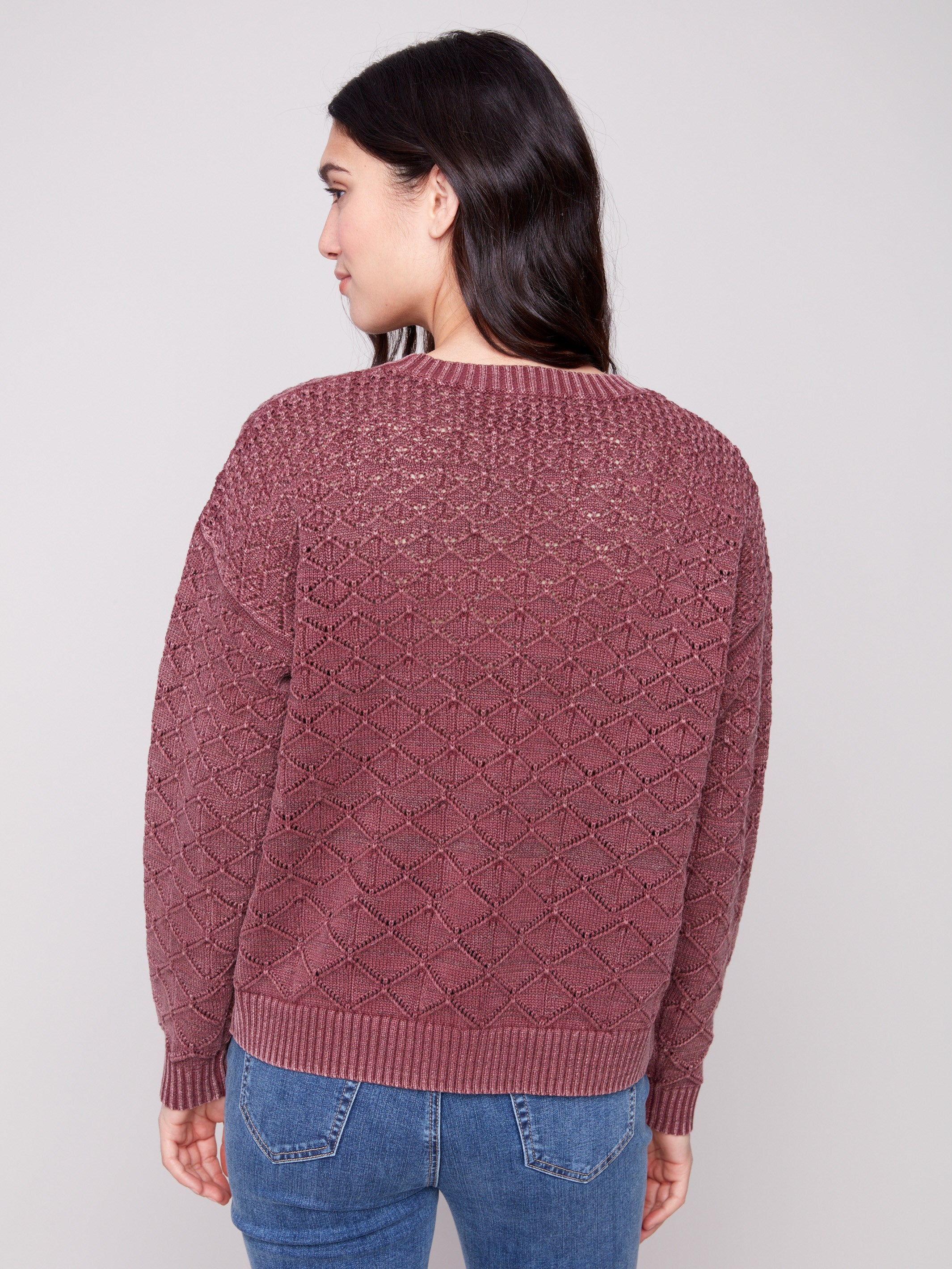 Elegant cabernet sweater showcasing intricate pointelle design for a chic appearance by Charlie B.