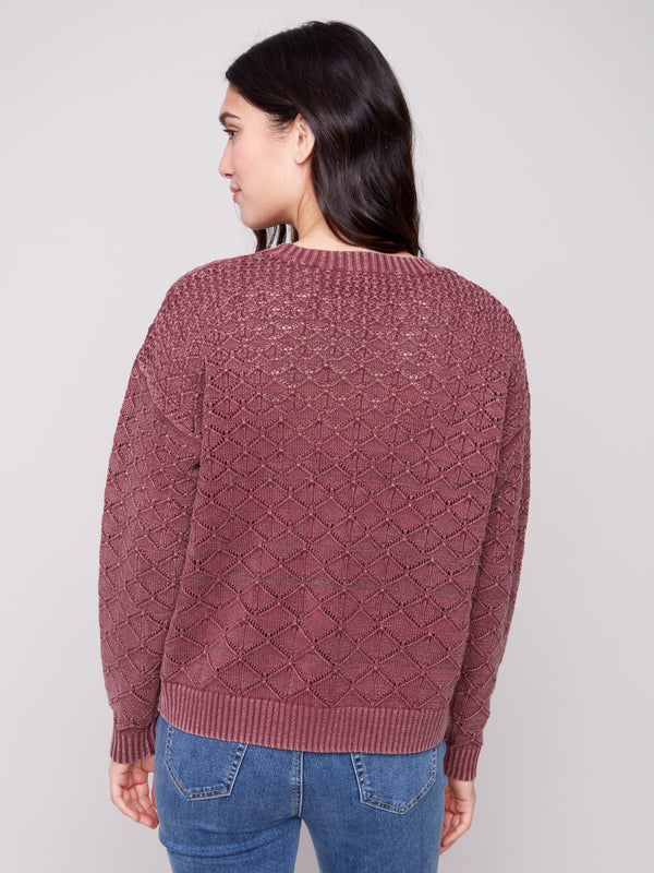 Elegant cabernet sweater showcasing intricate pointelle design for a chic appearance by Charlie B.
