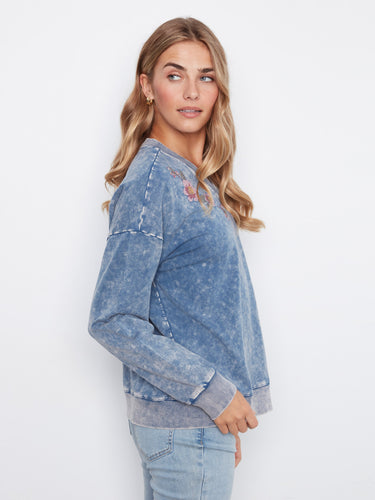 Embrace style with this drop shoulder design denim blue top, adorned with floral details by Charlie B.