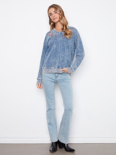 Denim blue V-neck terry top combining comfort and elegance with embroidered floral patterns by Charlie B.