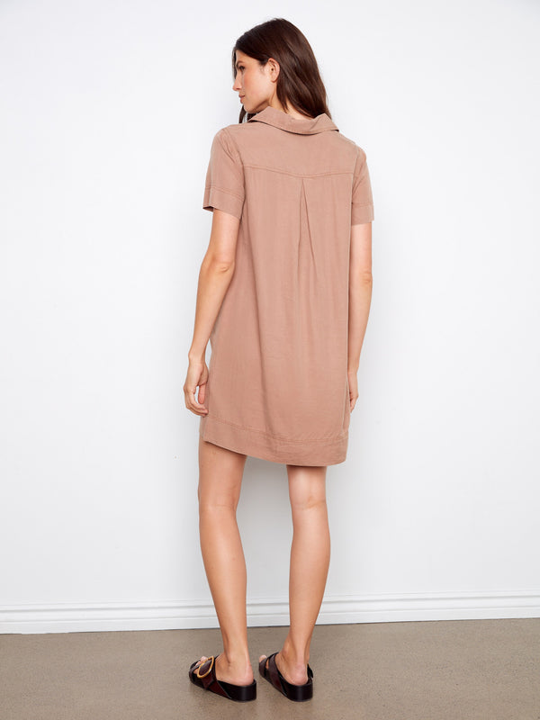 Knee length design offers a versatile and modest option for various settings, blending style with practicality effortlessly. By Charlie B.