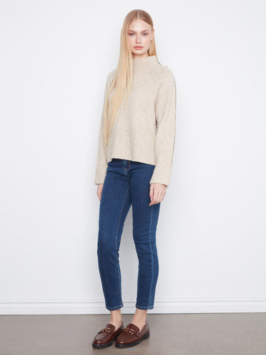 Chic mock neck design paired with stylish long raglan sleeves ensures warmth and fashion-forward appeal. By Charlie B.
