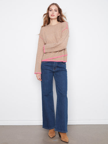 The asymmetrical hem adds a modern twist to this cozy sweater. By Charlie B.