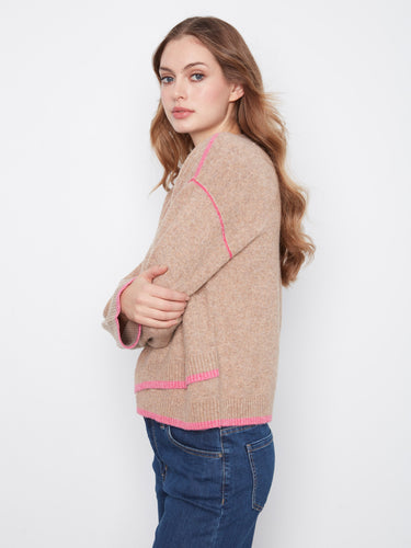 Wide sleeves enhance the laid-back aesthetic of this chic sweater. By Charlie B.