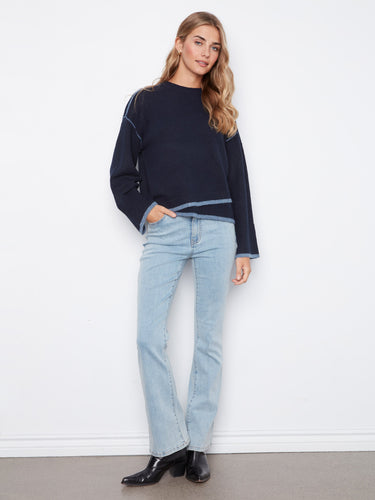 Chic navy sweater showcasing an asymmetrical hem, adding a modern touch to your everyday wardrobe. Ideal for layering by Charlie B.