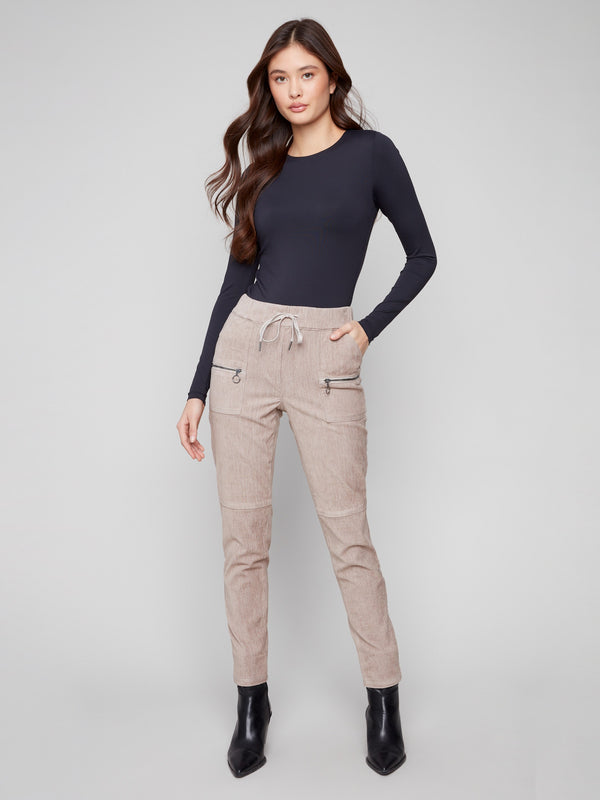 Almond corduroy jogger pants featuring a slim fit and zipper pockets, perfect for a chic yet casual look by Charlie B.