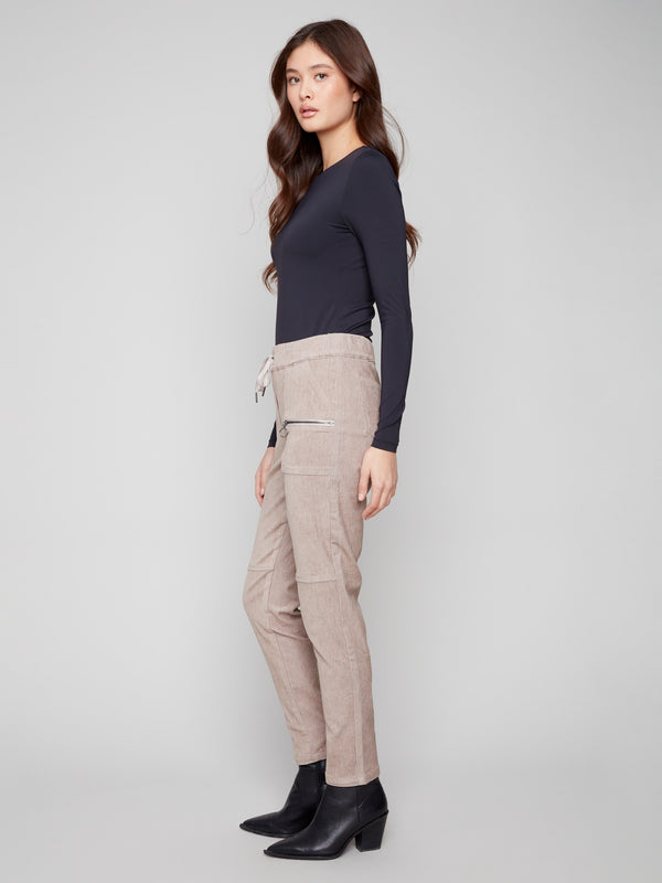 Mid-rise almond jogger pants in stretchy corduroy with two front zipper pockets, ideal for everyday wear by Charlie B.