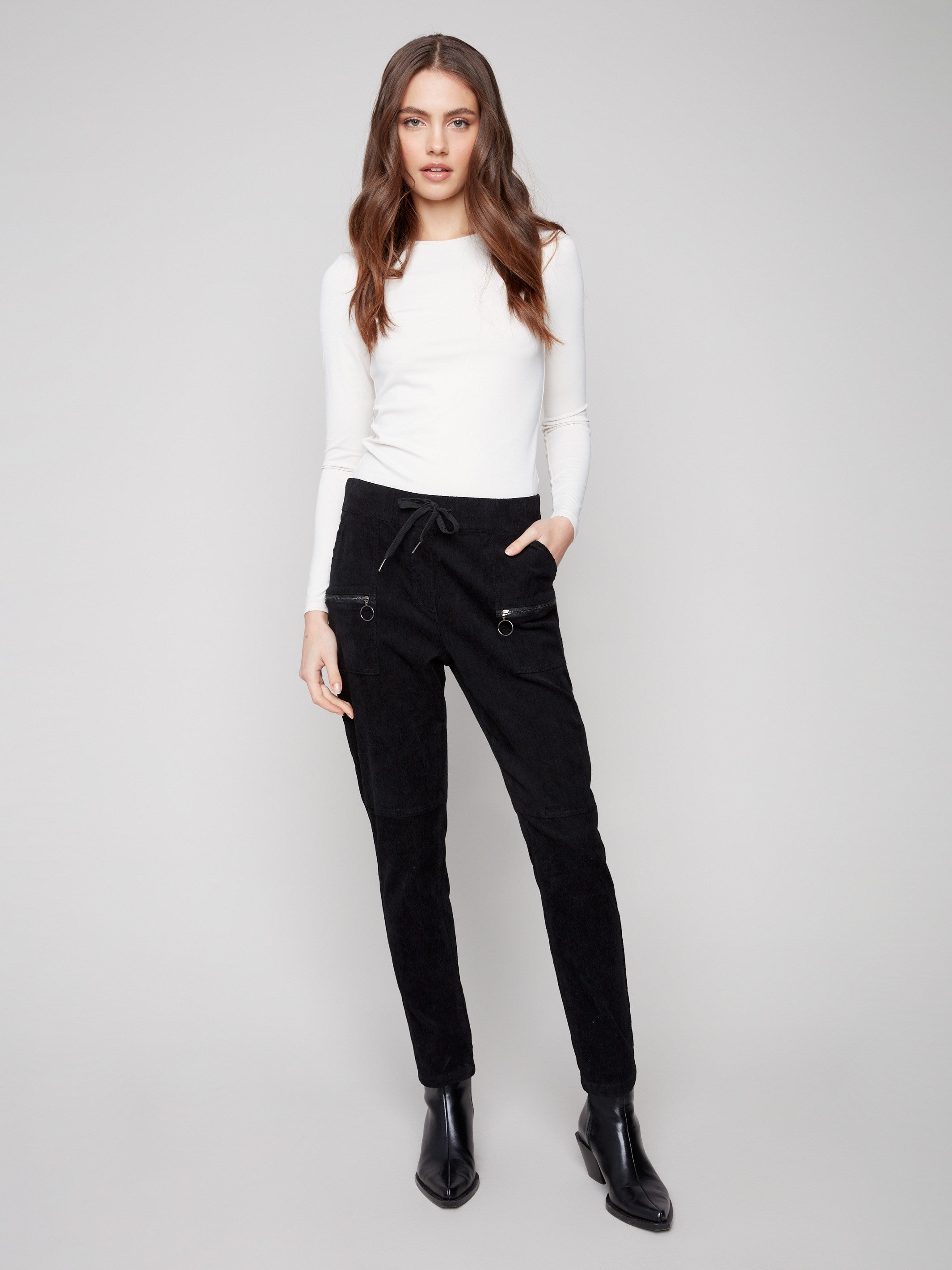 Black corduroy jogger pants featuring a slim fit and elastic waistband with drawstrings for comfort by Charlie B.