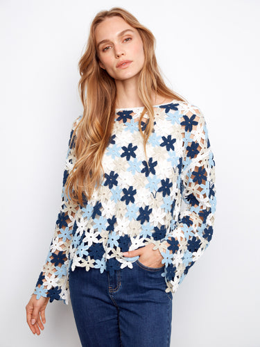 This delightful crochet top showcases drop shoulders for a relaxed fit, adorned with multicolored floral designs. Crafted by Charlie B.