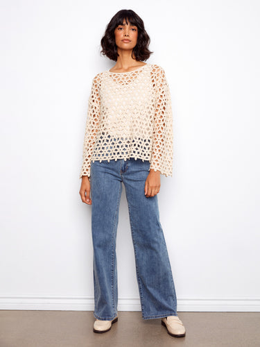 Chic top featuring drop shoulders, offering a relaxed and fashionable fit. Ideal for casual outings or layering by Charlie B.