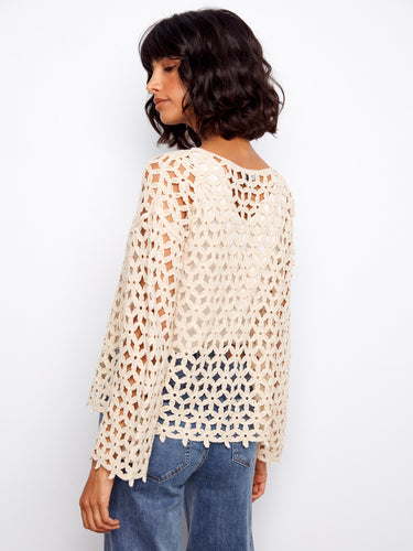 The intricate crochet design of this top offers unique texture and visual appeal for any outfit combination by Charlie B.