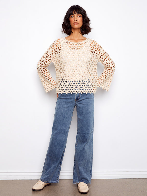 A versatile piece with timeless style, this crochet top can be dressed up or down for various occasions effortlessly by Charlie B.