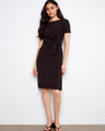 Elegant black dress featuring a boat neckline and waist tie for a flattering silhouette by Charlie B.