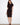 Elegant black dress featuring a boat neckline and waist tie for a flattering silhouette by Charlie B.