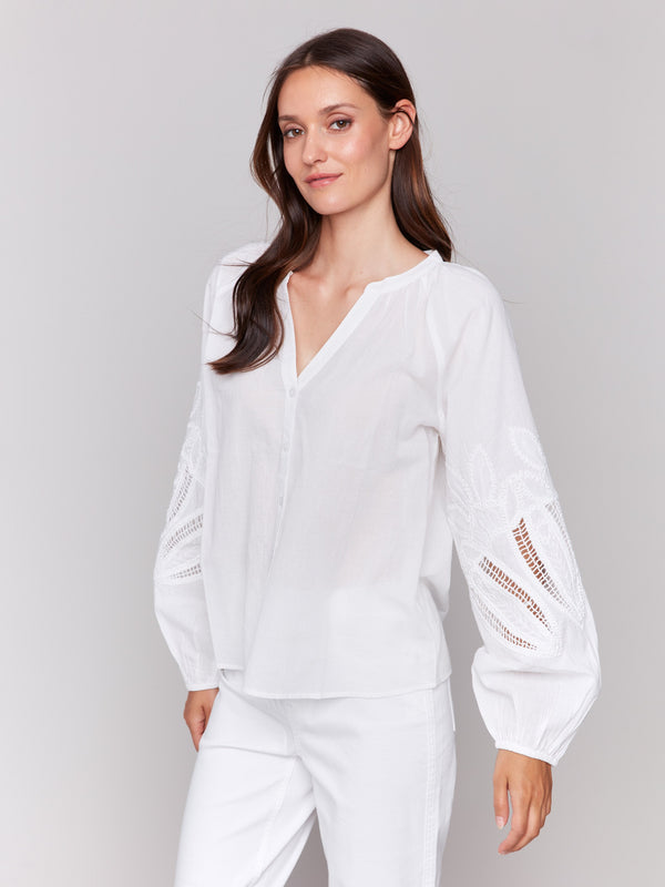 Elegant blouse showcasing artisan embroidery on the sleeves by Charlie B.