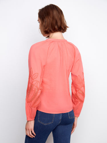 Coral top designed with elastic cuffs and detailed sleeve embroidery, blending comfort with style effortlessly. By Charlie B.