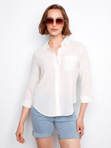 Versatile white top emphasizing its roll-up sleeves feature, ensuring comfort and style by Charlie B.