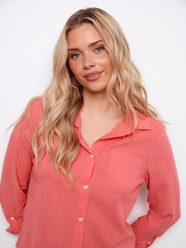 The coral shirt showcases an elegant chest pocket detail, made with soft 100% cotton material for everyday wear. By Charlie B.