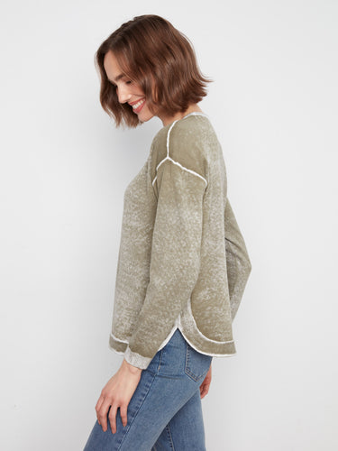 Stylish sweater in olive with a rounded hem, offering a relaxed fit and casual vibe. Designed by Charlie B.